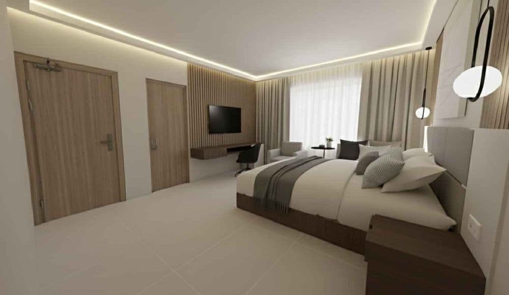 Deluxe room with a king bed against a warm timber slat wall and soft cove lighting